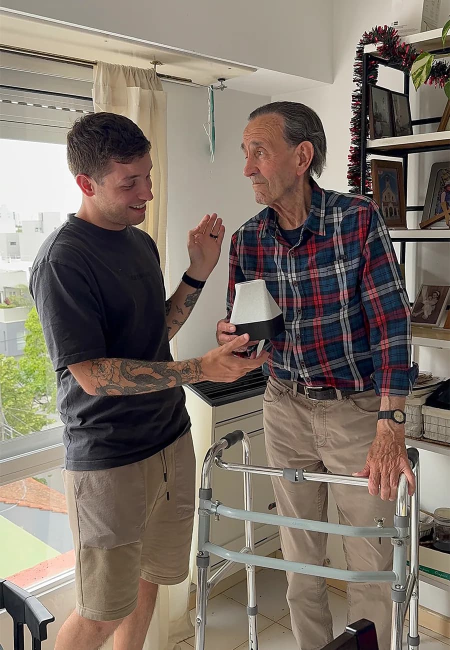 Juan with his grandfather, Ato, holding the first Ato prototype
